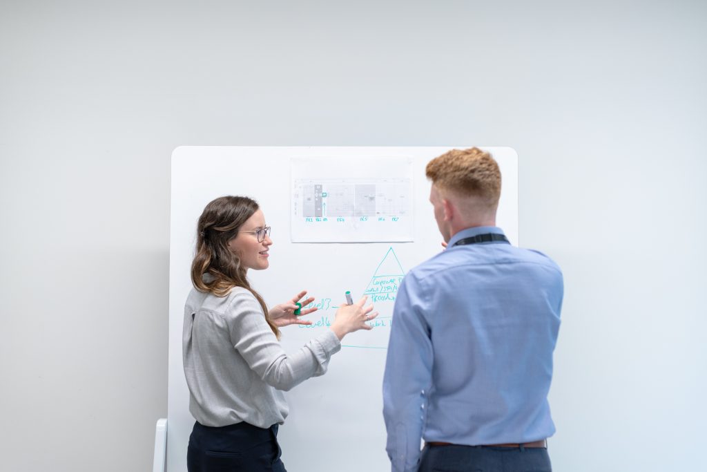 Female engineer discussing white board